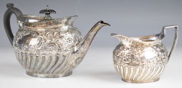 Victorian hallmarked silver teapot and milk jug with embossed decoration, London 1894, maker  W &