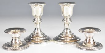 Two pairs of silver candlesticks, one pair marked Thailand sterling, the other pair marked 925,