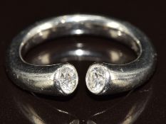 A platinum white gold 'Torque' ring with with two diamonds of approximately 0.22ct each, 9.6g,