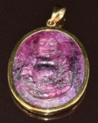 A 9k gold pendant set with a ruby cameo of approximately 42ct depicting a smiling Buddha, 11.6g, 2.5