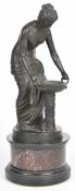 Bronze figure of a semi nude woman wearing a classical robe and holding a twin handled bowl, on