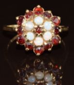 A 9ct gold ring set with opals and garnets in a cluster, 2.9g, size O