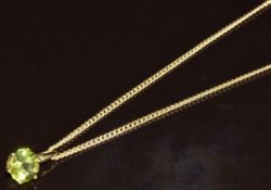 A 9ct gold pendant set with a round cut peridot of approximately 1.2ct, on 9ct gold chain, 3.4g,