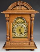 Mahogany cased mantel clock with ornate brass face, silvered dial, German movement and strike