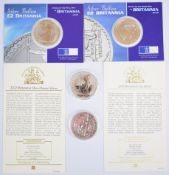 Four one ounce silver Britannia coins comprising 2000 and 2001 examples on Royal Mint cards and 2002