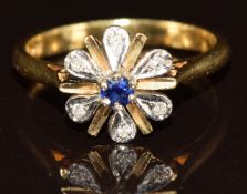 An 18ct gold ring set with a sapphire and diamonds in a flower cluster, 4.1g, size L