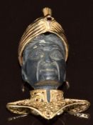 A blackamoor figure set in a yellow metal pendant set with a garnet (tests as 9k gold), 18.4g, 3.