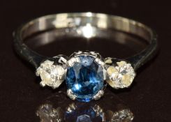 An 18ct white gold ring set with an oval cut sapphire of approximately 0.5ct and two round cut