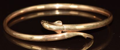 A 9ct gold bangle in the form of a dolphin, 5.3g