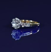 An 18ct gold ring set with an old cut diamond of approximately 1.8ct and with further diamonds to