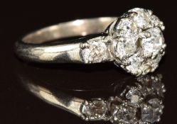 A platinum ring set with a cluster of diamonds, the centre diamond approximately 0.28ct, 4.7g,