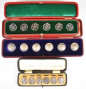 Three cased sets of hallmarked silver buttons, one an Art Nouveau set, Sheffield 1903, maker James