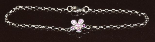 An 18k white gold bracelet in the form of a flower set with pink sapphires, 2.6g, 18.5cm
