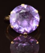 A 9ct gold ring set with a round cut synthetic colour change sapphire of approximately 9ct, 4.9g,