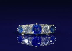 An 18ct gold ring set with three sapphires of approximately 0.7ct, 0.3ct and 0.3ct, two old cut