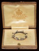 A 9ct gold brooch set with rose cut diamonds and pearls in a wreath design, in original Asprey