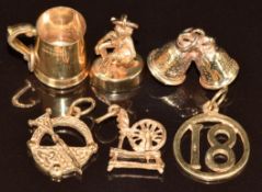 Six 9ct gold charms including tankard, bells, 18th, etc, 11.3g