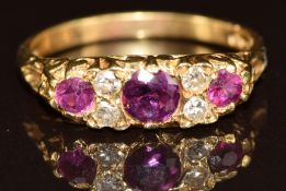 An 18ct gold ring set with three rubies and four diamonds, 2.6g, size L