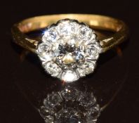 An 18ct gold ring set with a cluster of diamonds, the centre diamond 0.45ct, 4.1g, size M/N