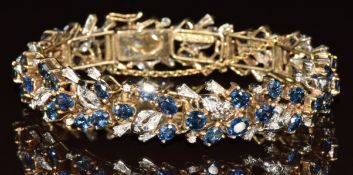A 14ct gold bracelet set with fifty-two oval cut sapphires, each approximately 0.2ct and eighty