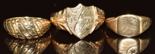 A 9ct gold signet ring, a smaller 9ct gold signet ring and a 9ct gold ring, 6.4g, size L & R