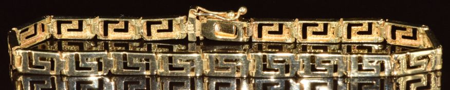A 14k gold bracelet made up of Greek key rectangular panels, 7.7g, 18cm