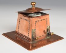Arts & Crafts hammered canted inkwell with hinged lid, porcelain liner and pen holder, W10 x D10 x