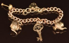 A 9ct gold charm bracelet with four 9ct gold charms including coffee pot, tea pot, palm tree and