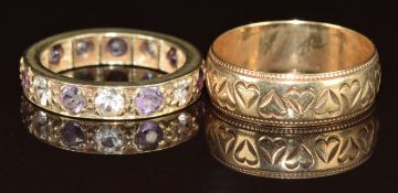 A 9ct gold wedding band with engraved heart decoration and a 9ct gold ring set with amethysts and