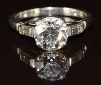 A c1920 platinum ring set with a transitional cut diamond of approximately 2ct and with a baguette