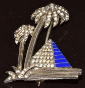 Art Deco silver brooch in the form of a palm trees and a pyramid, set with paste and blue enamel,