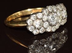 An 18ct gold ring set with diamonds in three clusters, the centre diamond approximately 0.25ct, 4.