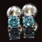 A pair of 14k white gold earrings each set with a blue diamond of approximately 0.45ct, with GIE