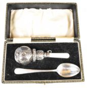 Cased George V hallmarked silver baby's rattle and spoon set, the rattle formed as a chorister or