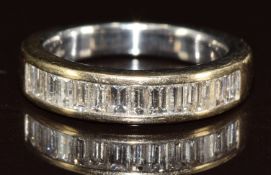 An 18ct white gold ring set with fourteen baguette cut diamonds, 5g, size H