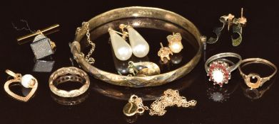 A collection of jewellery including silver bangle, silver ring set with an opal surrounded by
