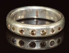 A silver ring set with seven round cut diamonds, 8.1g, size W