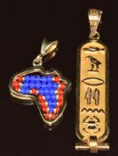 An 18ct gold Egyptian pendant (2.8g, 4.7cm) and a 14ct gold pendant in the form of Africa set with