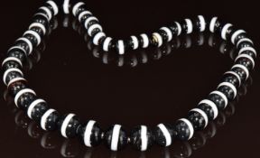 A necklace made up of graduated banded agate beads, largest bead 18mm, smallest 10mm, 180g, 60cm