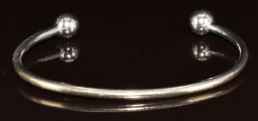 A 9ct white gold torque bangle, 12.3g,