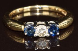A 14k gold ring set with a diamond and two sapphires, 3.4g, size O