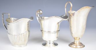 Three various hallmarked silver milk jugs, one with ribbed lower body, height of tallest 12.5cm,