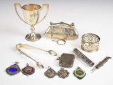 Hallmarked silver items comprising SBSMC trophy cup, sugar tongs, napkin ring, vesta case, purse,