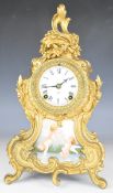 Ansonia New York USA gold painted Rococo style mantel clock with porcelain panel of two winged