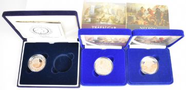 Three Royal Mint cased silver proof crown coins comprising 2005 Horatio Nelson, 2005 Trafalgar and