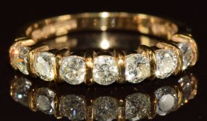 A 9ct gold ring set with seven round cut diamonds, each approximately 0.12ct, 2.5g, size M