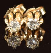 A pair of 14k gold earrings each set with a round cut diamond of approximately 0.14ct, 0.8g