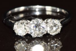 A c1930 platinum ring set with three diamonds of approximately 0.38ct, 0.25ct and 0.25ct, 2g, size