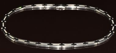A steel necklace made up of twenty- five rectangular links each set with five round cut diamonds,