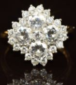 An 18ct gold ring set with four diamonds, each approximately 0.4ct surrounded by further diamonds,